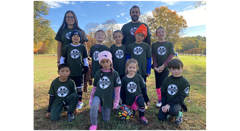 nine soccer team kids with their two coaches